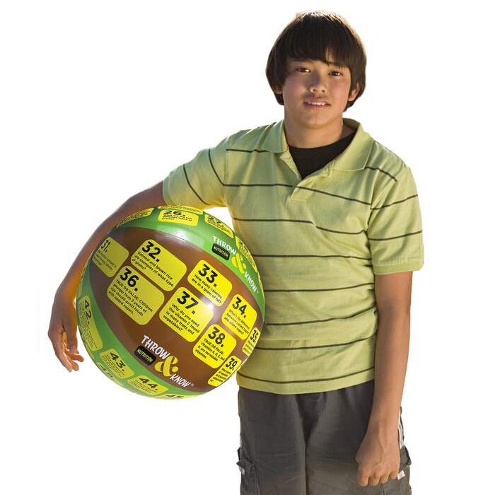 Older child holding Nutrition Throw & Know Activity Ball, health education inflatable ball with questions, Health Edco, 78006