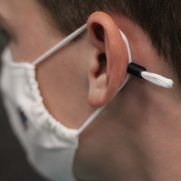 Zinc Miracle Mask by Health Edco, side view of teenage boy in one-size-fits-most mask showing adjustable ear toggle, 78866