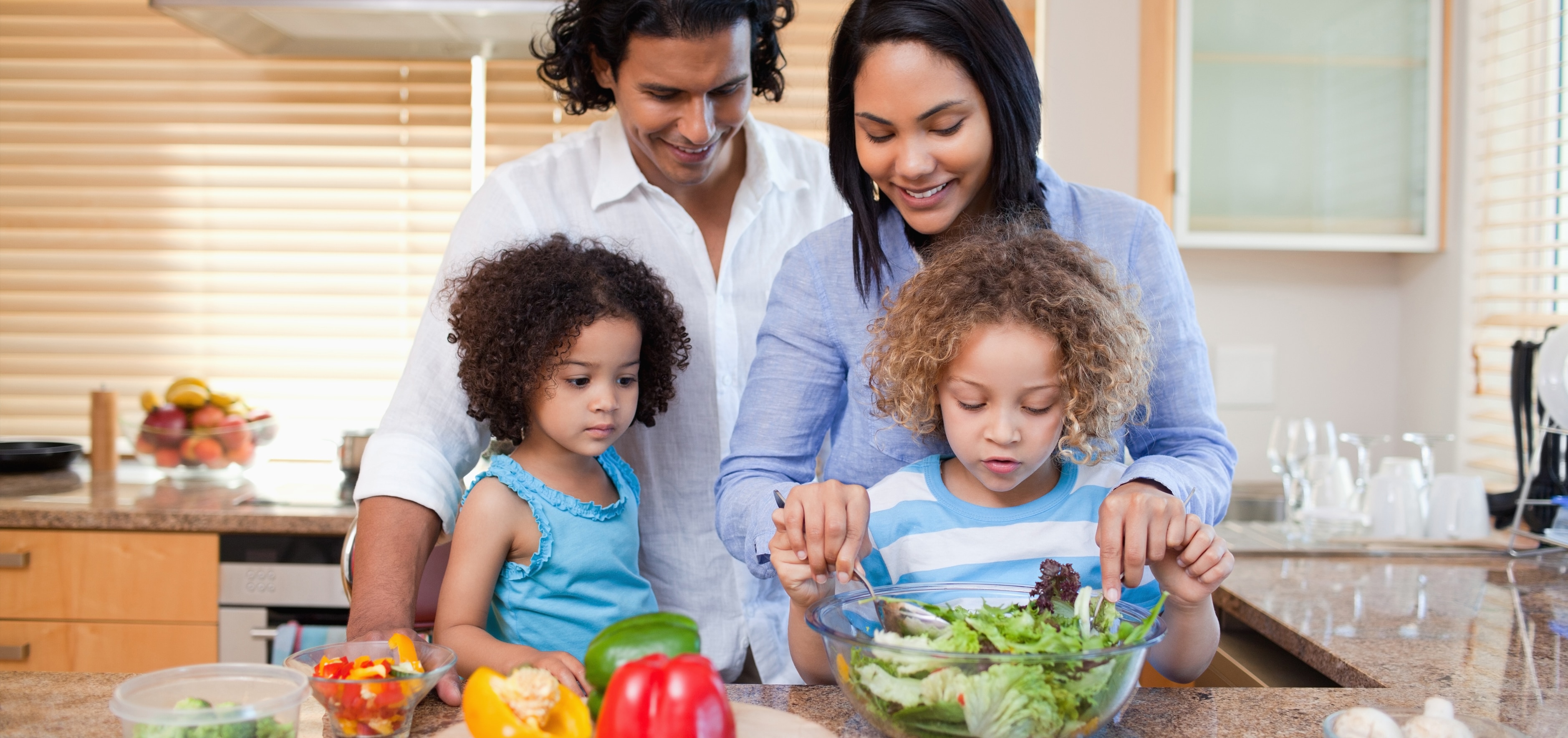 Parents and children making a healthy salad