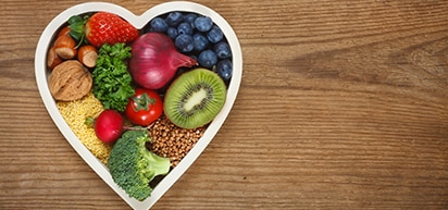 heart-shaped plate filled with healthy foods