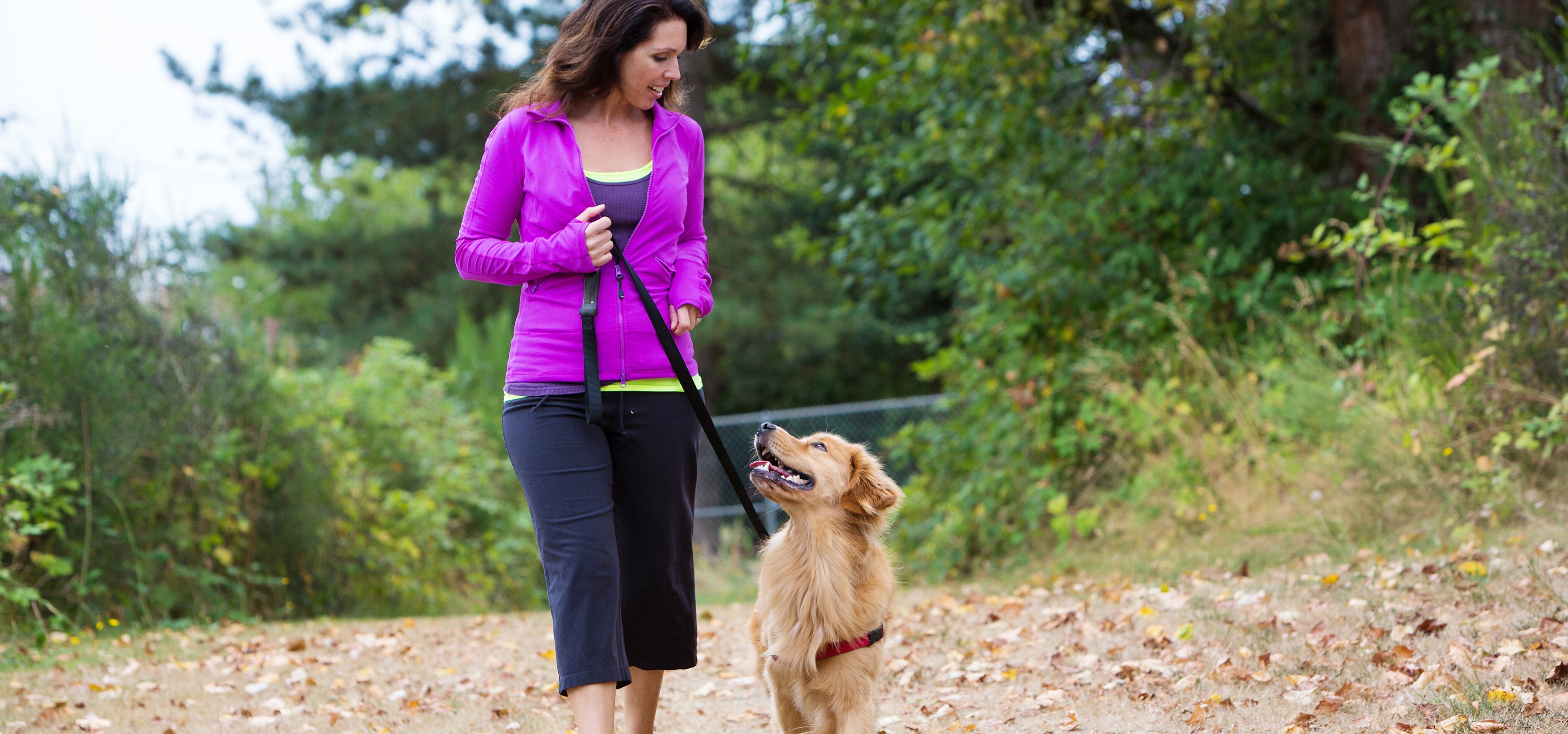 woman walking dog in park