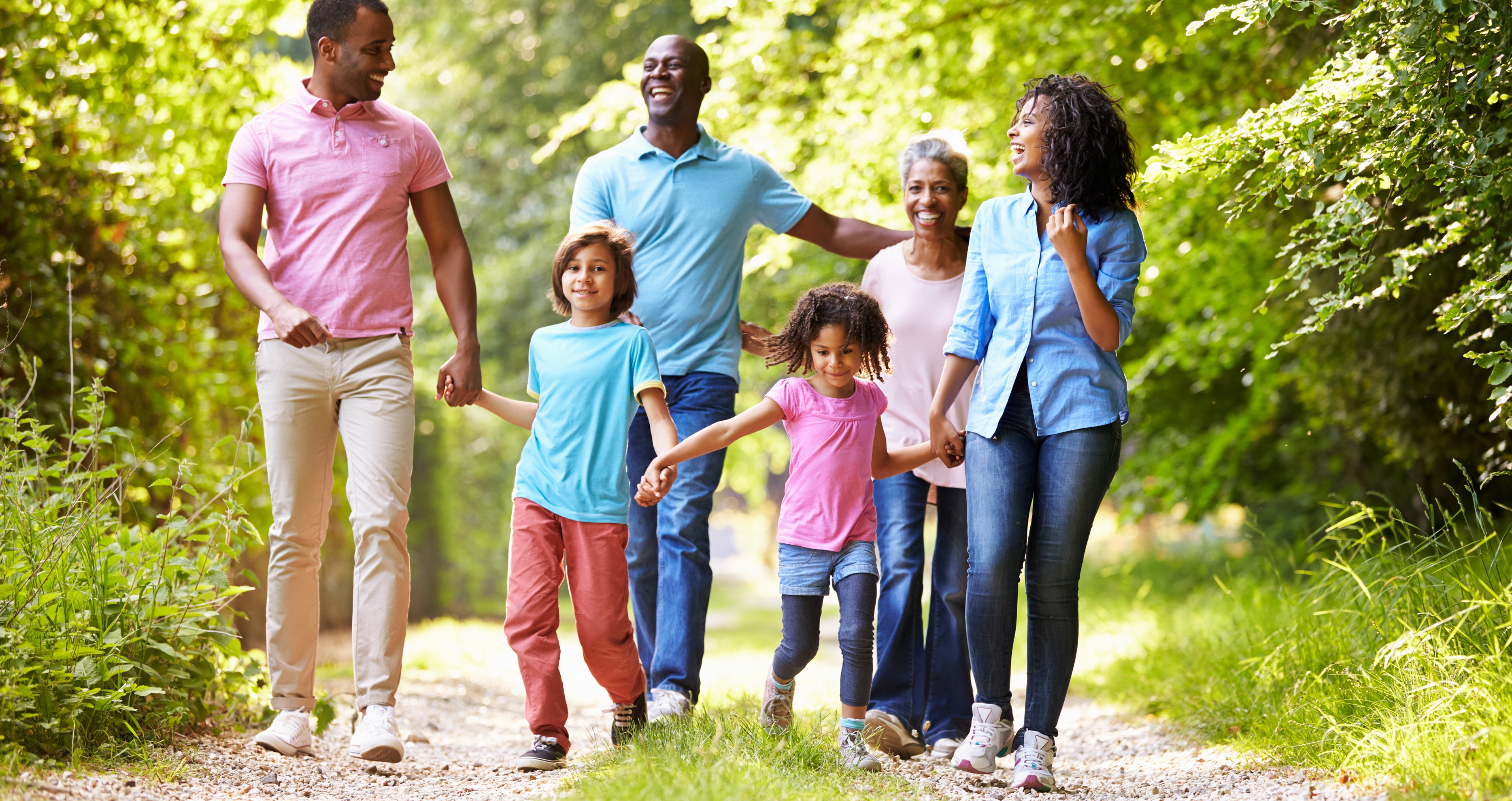 Multiple generations of a family enjoying a walk for physical activity