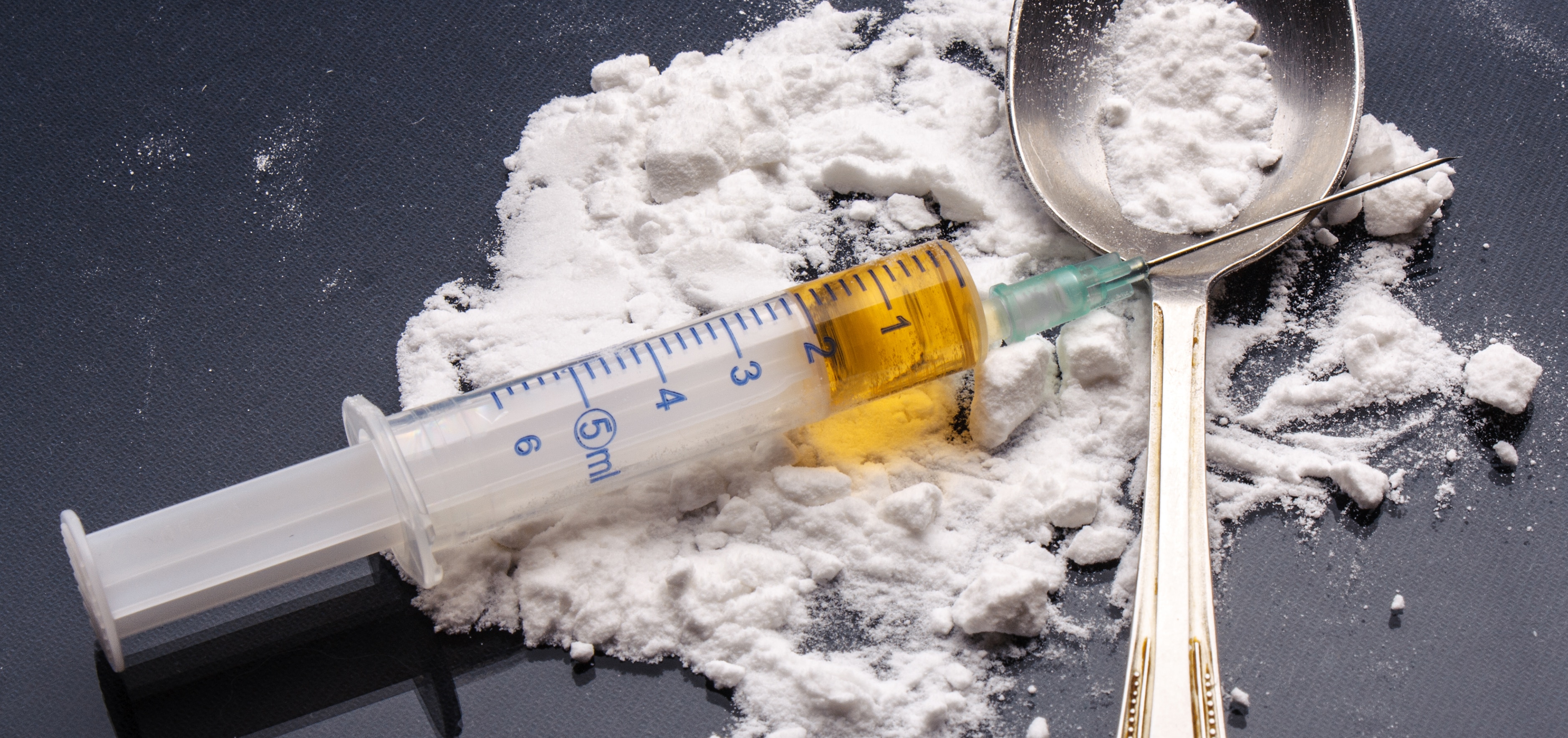 Powdered heroin in a spoon and syringe