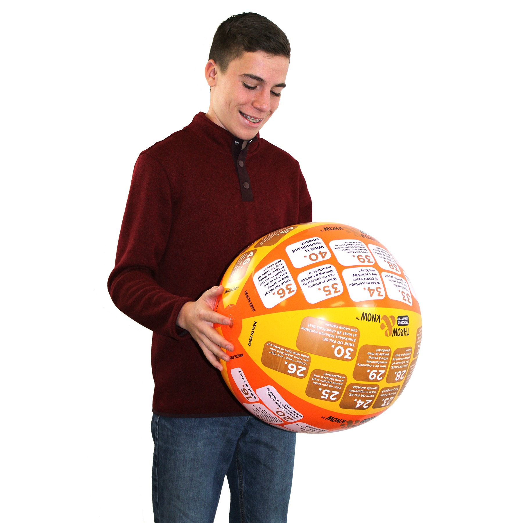 Teenage boy smiling and reading Health Edco’s Tobacco & E-Cigarettes Throw & Know Activity Ball